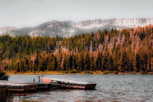 Boat on the lake with pine tree and mountain view background at Mammoth Lakes California USA Mural by Timmy333