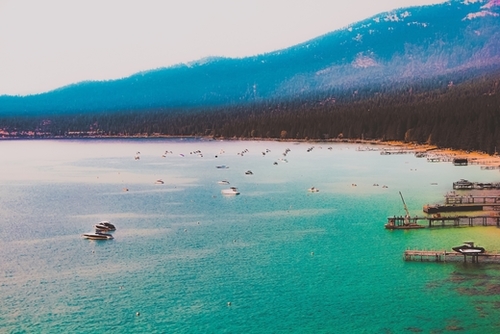 Boat on the water and mountain background at Lake Tahoe Nevada USA Mural by Timmy333