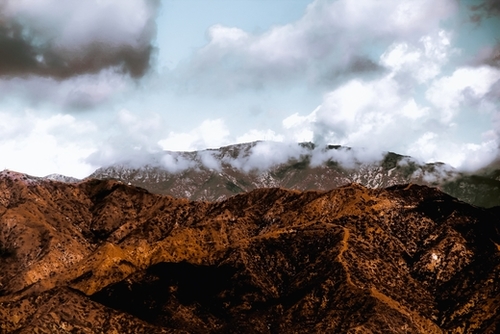 View from the hiking trail with mountain view and blue cloudy sky to Hollywood sign Los Angeles California USA Mural by Timmy333