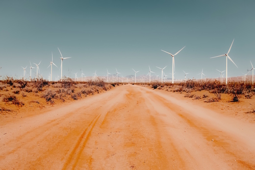 Wind turbine in the desert with sandy road at Kern County California USA Mural by Timmy333