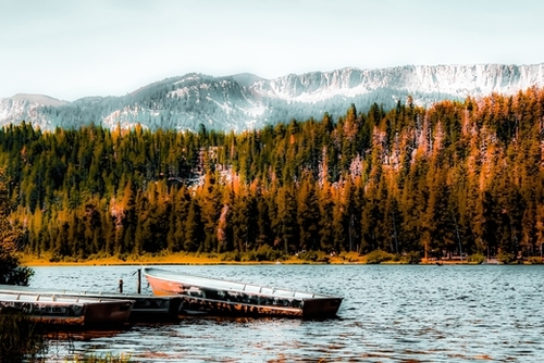 boat on the lake with pine tree and mountain background at Mammoth Lakes, California, USA Mural by Timmy333