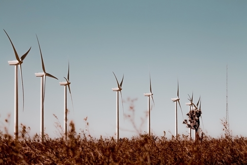 Wind turbine in the desert with blue sky at Kern County California USA Mural by Timmy333