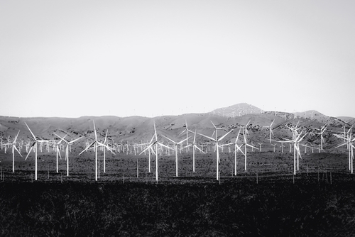 wind turbine in the desert with mountain background in black and white Mural by Timmy333