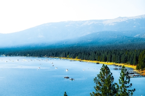 boats on the blue lake with pine tree and mountains at Lake Tahoe, Nevada, USA Mural by Timmy333