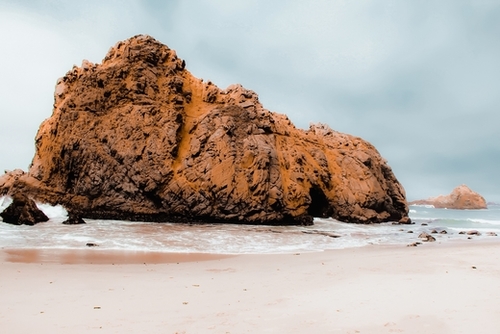 Big stone in the sandy beach at Pfeiffer Beach, Big Sur, California, USA Mural by Timmy333