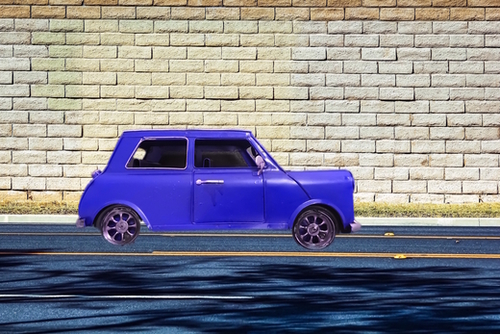 blue classic car on the road with brick wall background Mural by Timmy333