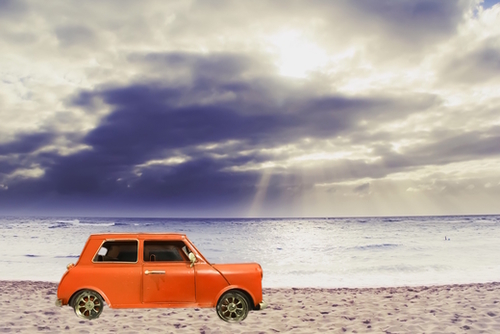 orange classic car on the sandy beach with beautiful sky and beach background Mural by Timmy333