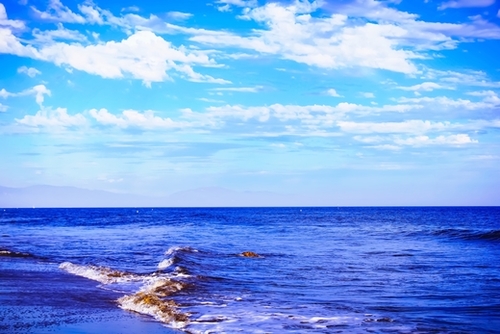 blue ocean view with blue cloudy sky in summer Mural by Timmy333