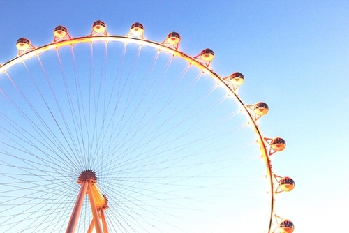 orange Ferris Wheel in the city with blue sky  Mural by Timmy333