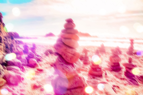 stone balancing at the sandy beach with summer bokeh light Mural by Timmy333