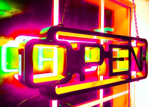 night light with open neon sign in pink yellow green background Mural by Timmy333